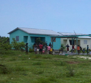 A housing project and pump built by a local Haitian organization.